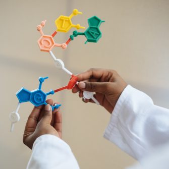 Chemist holding molecule model in hands